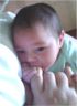 Ana at 2 weeks of age, chewing Grandma Kathy O's finger